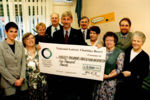 The first funding KPAIS ever received. The group shot includes Sir George Howarth MP.